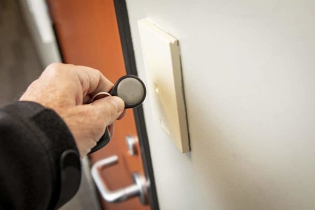 picture of man using a key fob to open a door