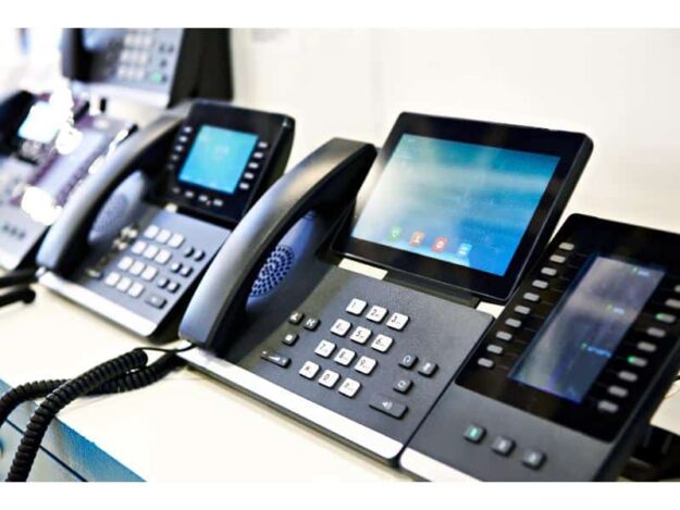 AdobeStock_283777534 voip phones on a table