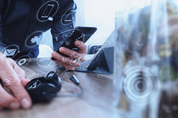 Man using VOIP headset with digital tablet computer docking keyboard.