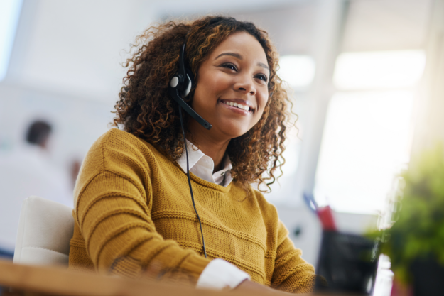 Smiling Black woman wearing a voip headset for consulting.
