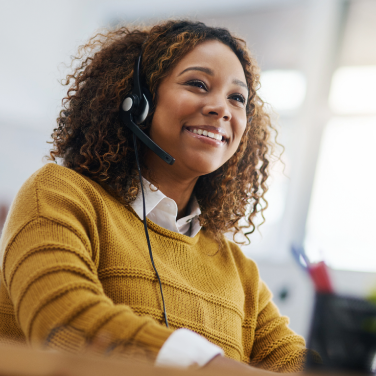 Why More Businesses Are Switching to VoIP in Austin, TX Smiling Black woman wearing a voip headset for consulting.
